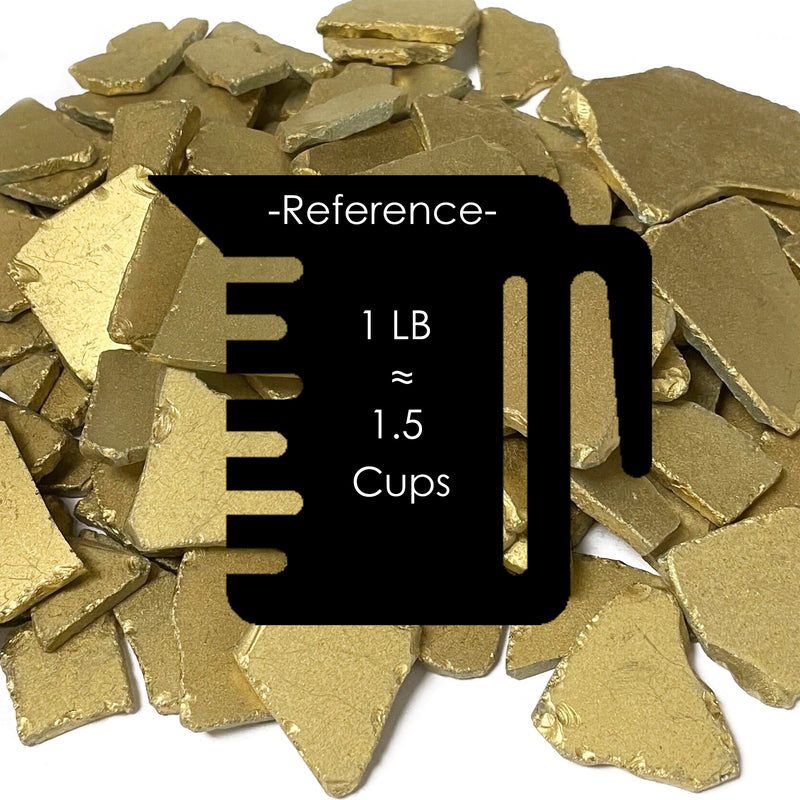 Gold-colored metal碎片 with a reference label for weight and volume.