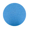 Blue colored sand arranged in a circular shape on a white background