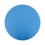 Blue colored sand arranged in a circular shape on a white background