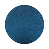 Navy Blue colored sand arranged in a circular shape on a white background