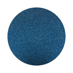 Navy Blue colored sand arranged in a circular shape on a white background