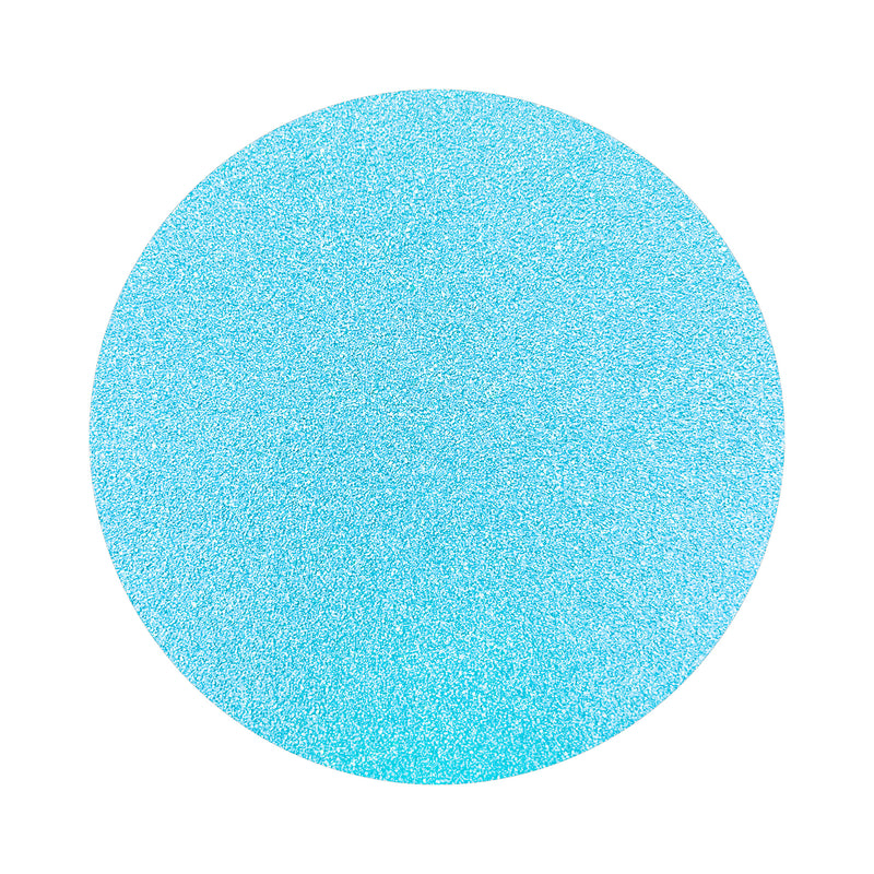 Sky Blue colored sand arranged in a circular shape on a white background