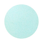 Turquoise Blue colored sand arranged in a circular shape on a white background