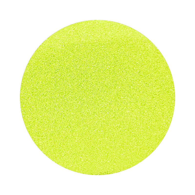Apple Green colored sand arranged in a circular shape on a white background