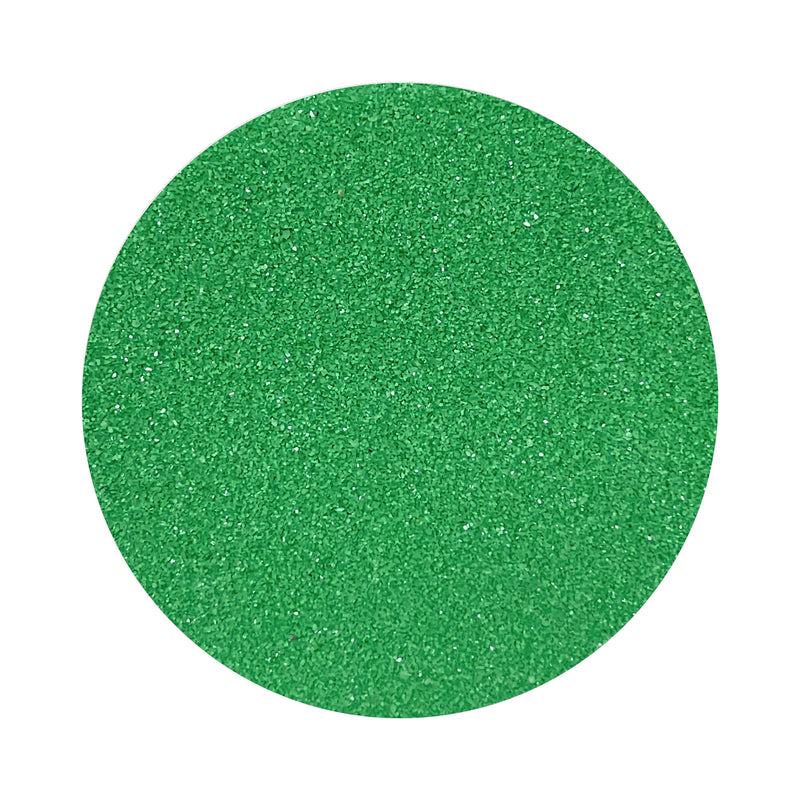 Emerald Green colored sand arranged in a circular shape on a white background