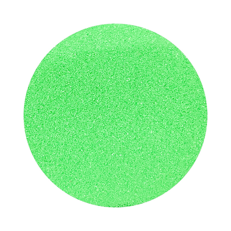 Light Green colored sand arranged in a circular shape on a white background