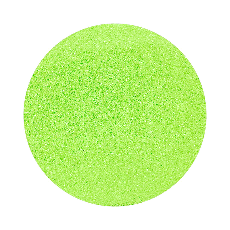 Lime Green colored sand arranged in a circular shape on a white background