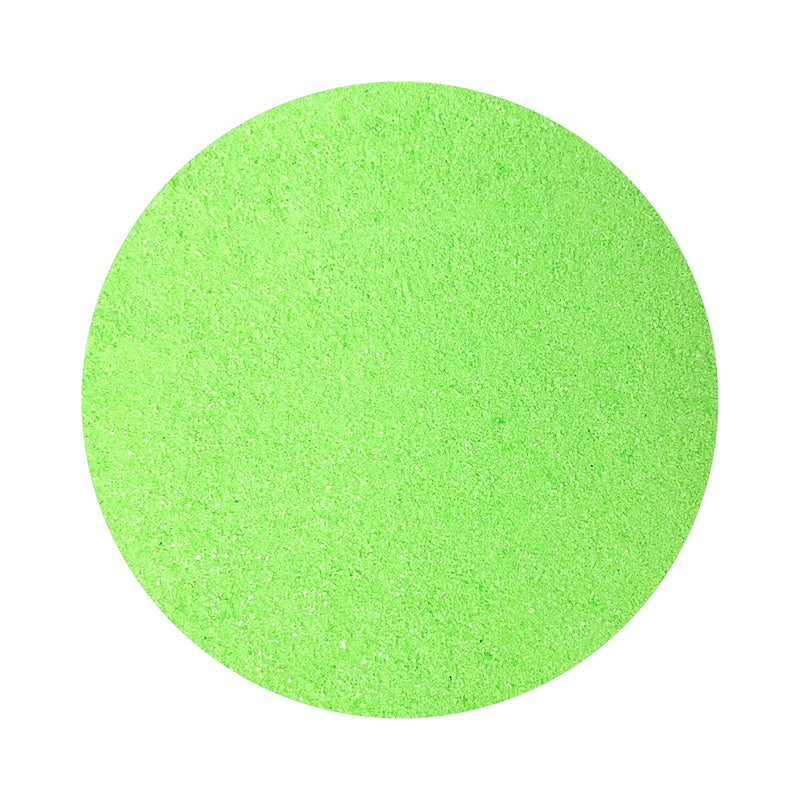 Neon Green colored sand arranged in a circular shape on a white background