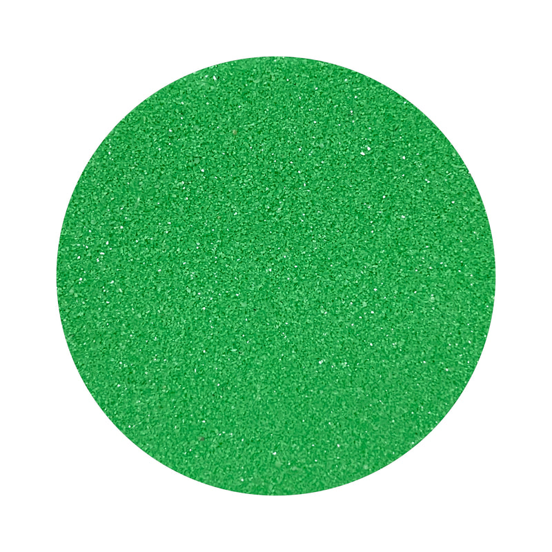 Hills Green colored sand arranged in a circular shape on a white background