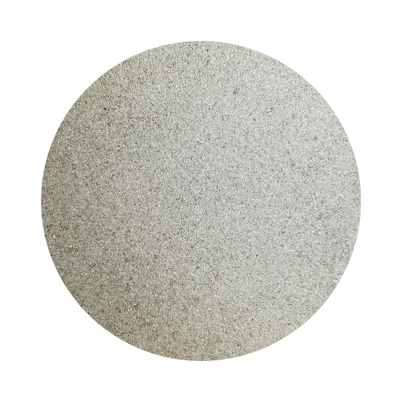 Light Grey colored sand arranged in a circular shape on a white background