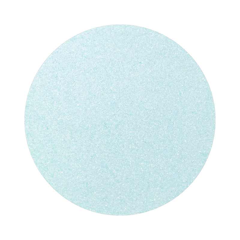 Light Blue colored sand arranged in a circular shape on a white background