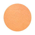 peach orange colored sand arranged in a circular shape on a white background