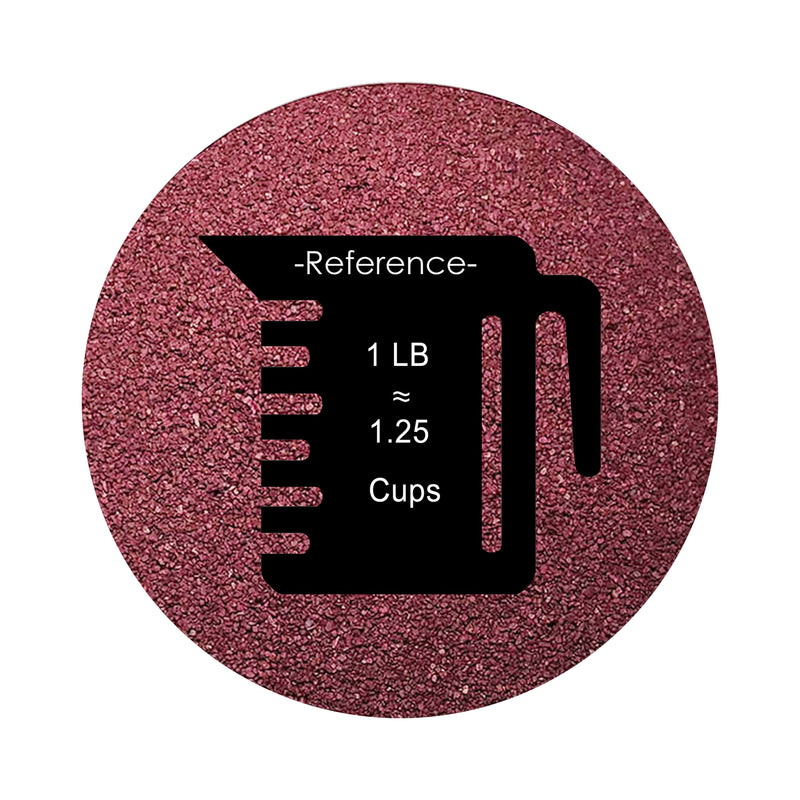 Burgundy colored sand arranged in a circular shape on a white background colored sand in a circular shape with a measuring cup showing quantity.