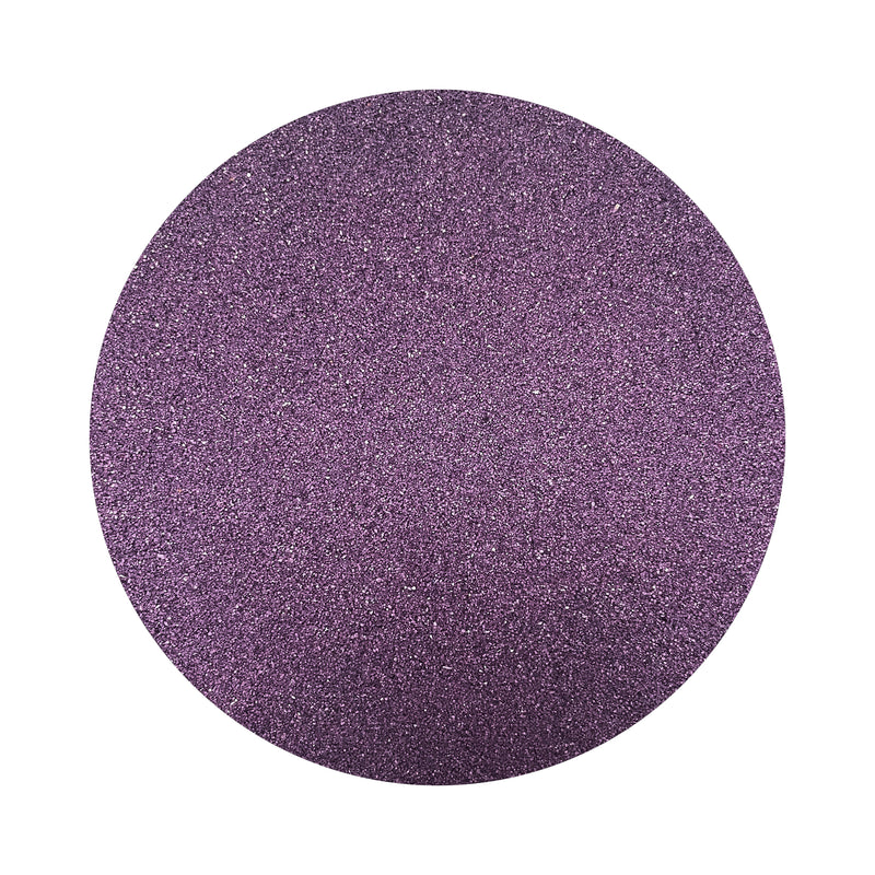 Dark Purple colored sand arranged in a circular shape on a white background