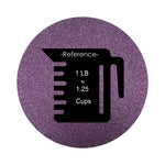 Dark Purple colored sand arranged in a circular shape on a white background colored sand in a circular shape with a measuring cup showing quantity.