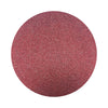 Burgundy Red colored sand arranged in a circular shape on a white background