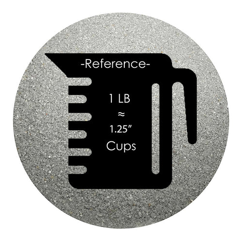 Silver colored sand arranged in a circular shape on a white background colored sand in a circular shape with a measuring cup showing quantity.