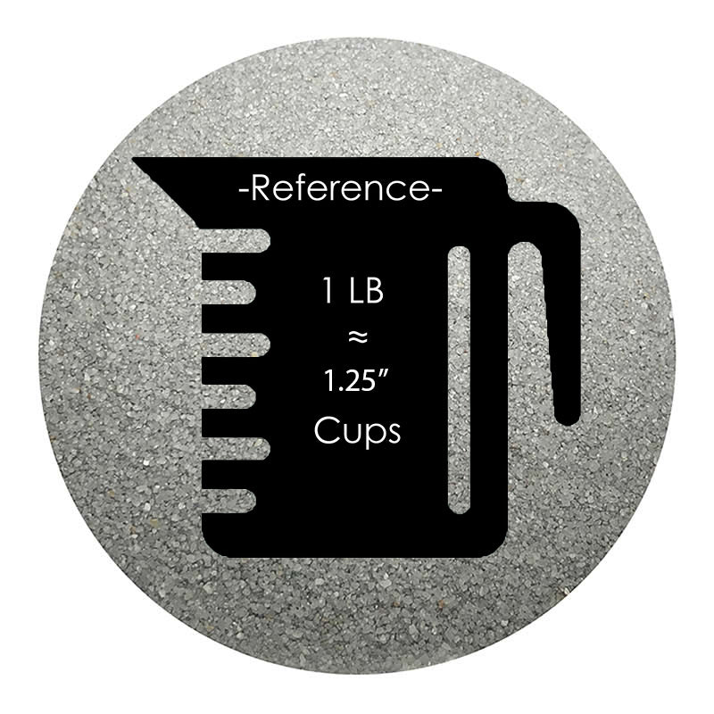 Silver colored sand arranged in a circular shape on a white background colored sand in a circular shape with a measuring cup showing quantity.