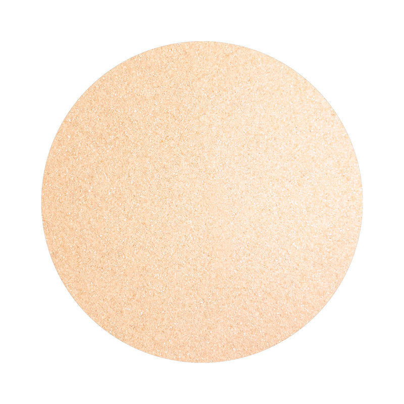 Light Peach colored sand arranged in a circular shape on a white background
