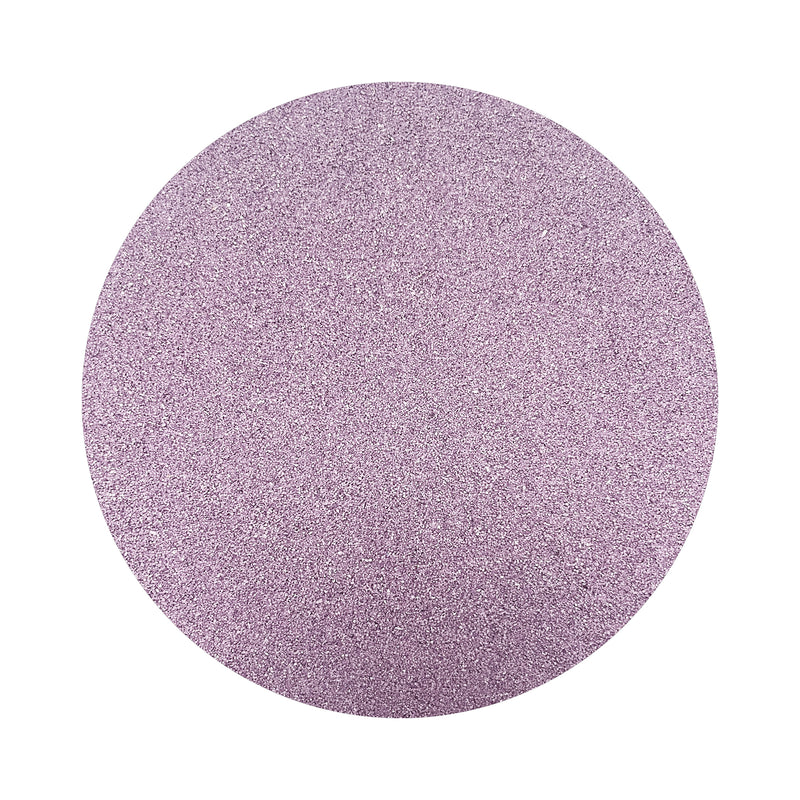 violet colored sand arranged in a circular shape on a white background