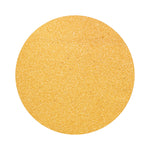 Mustard Yellow colored sand arranged in a circular shape on a white background