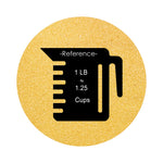 Mustard Yellow colored sand arranged in a circular shape on a white background colored sand in a circular shape with a measuring cup showing quantity.