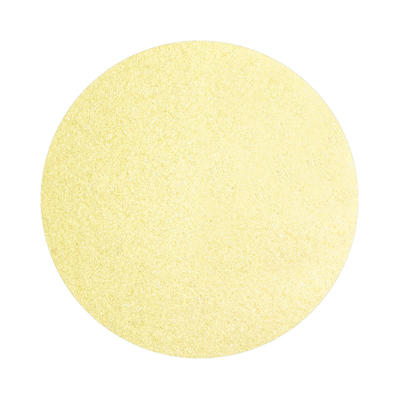 Buttermilk Yellow colored sand arranged in a circular shape on a white background