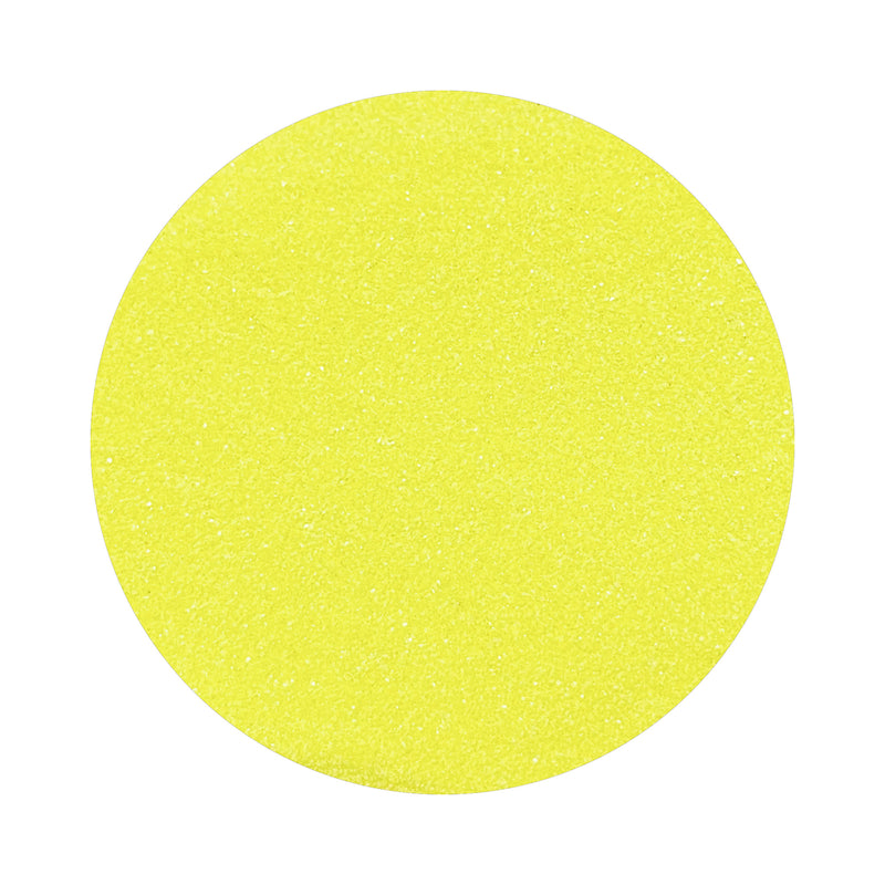 Lemon Yellow colored sand arranged in a circular shape on a white background