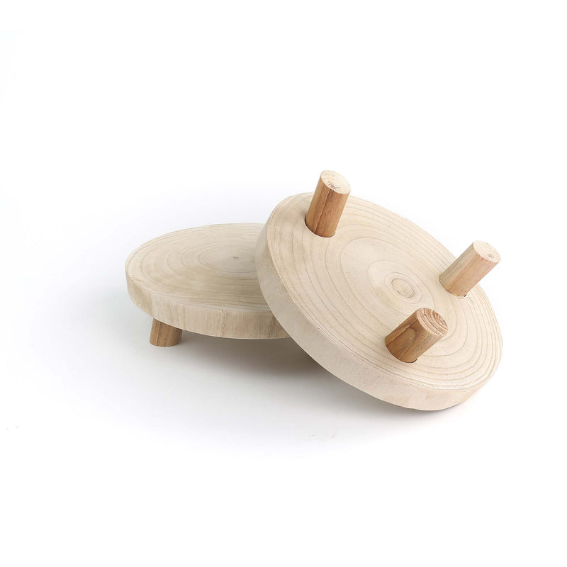 Two wooden coasters with legs on a white background