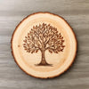 Wooden coaster with a tree engraving on a wooden surface