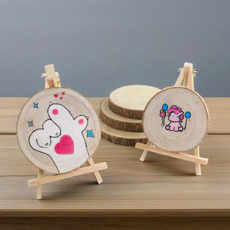 Two wooden coasters with hand-drawn designs on stands against a gray background