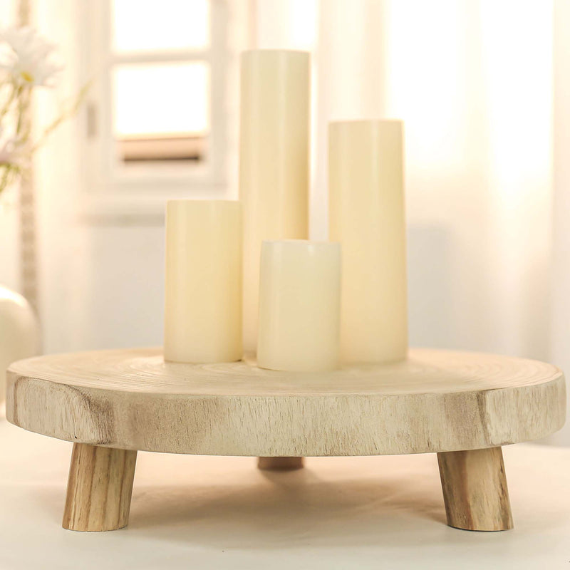 Wooden candle holder with three candles on a light background