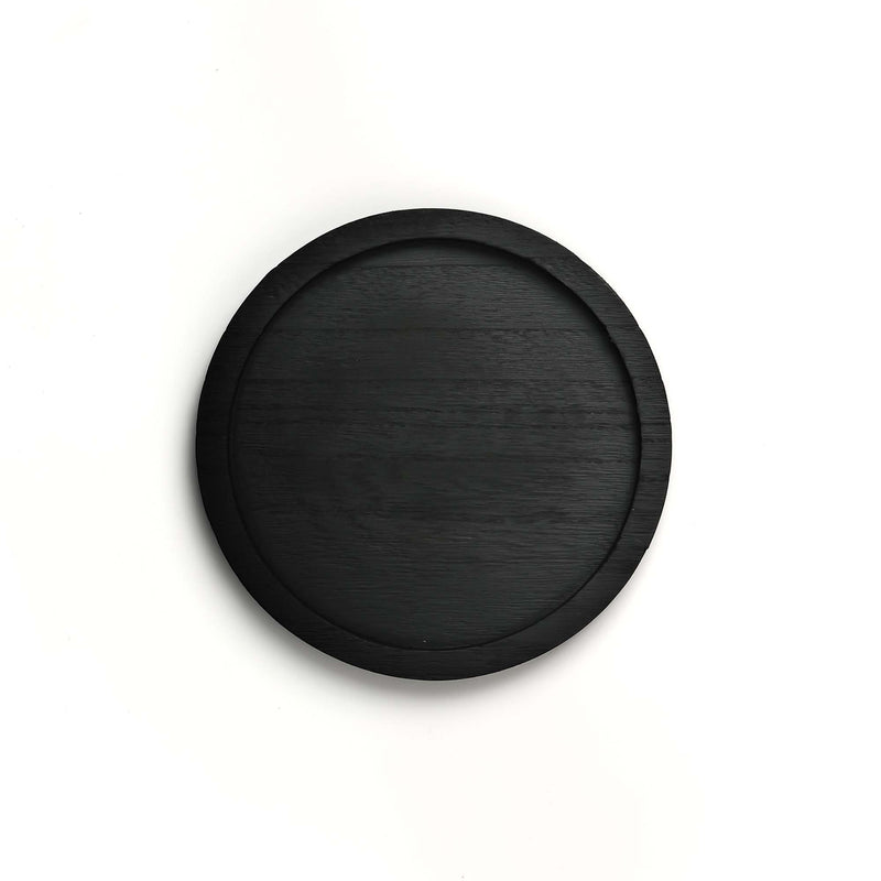 Black circular object on a white background