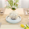 Decorative vase with floral design on a table setting