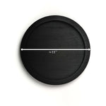 Black round tray with measurement label on a white background