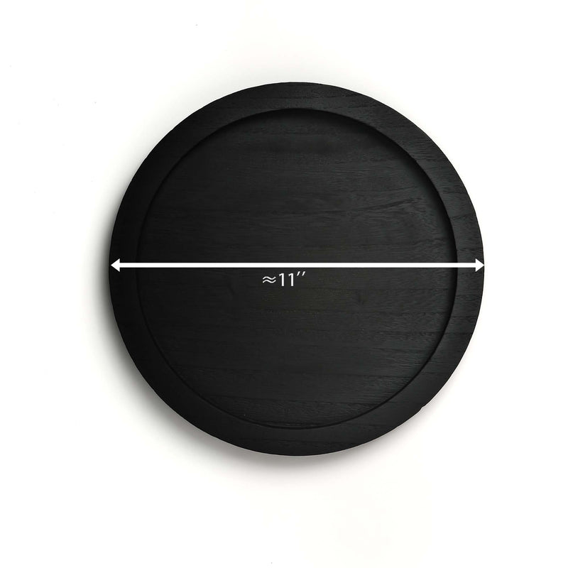 Black round tray with measurement label on a white background