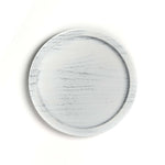 Round marble-patterned plate on a white background