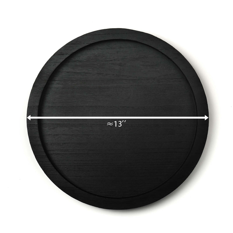 Black circular object with a measurement label indicating approximately 13 inches on a white background
