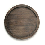 Round wooden tray with a dark brown finish on a white background
