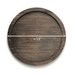 Wooden round tray with measurement label on a white background