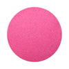 Fuchsia colored sand arranged in a circular shape on a white background
