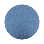 cobalt blue colored sand arranged in a circular shape on a white background