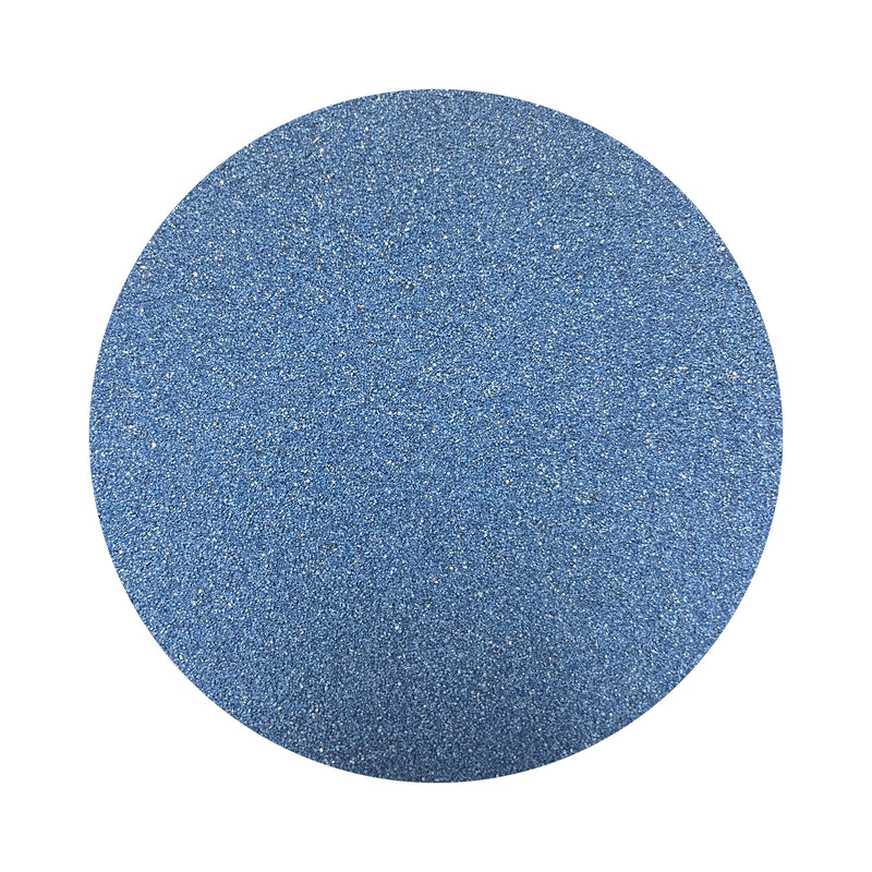 cobalt blue colored sand arranged in a circular shape on a white background