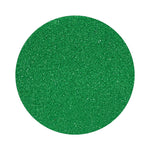 Dark green colored sand arranged in a circular shape on a white background