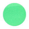 Green colored sand arranged in a circular shape on a white background