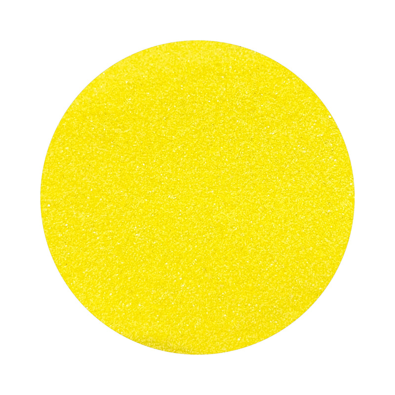 yellow colored sand arranged in a circular shape on a white background