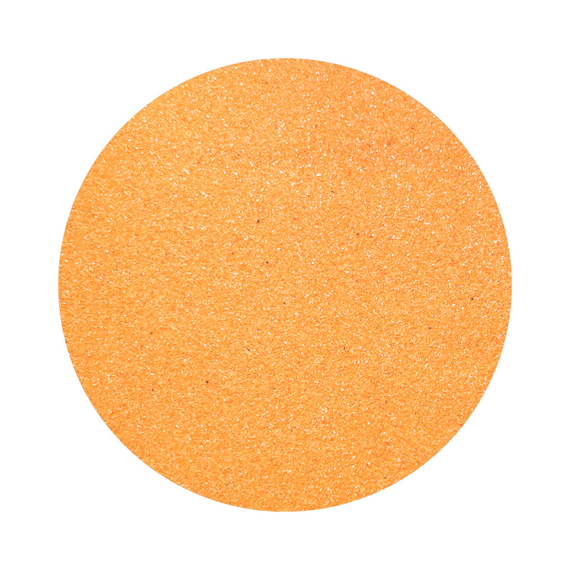 orange colored sand arranged in a circular shape on a white background