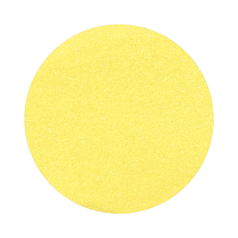 light yellow colored sand arranged in a circular shape on a white background