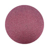 Wine colored sand arranged in a circular shape on a white background