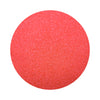 red colored sand arranged in a circular shape on a white background